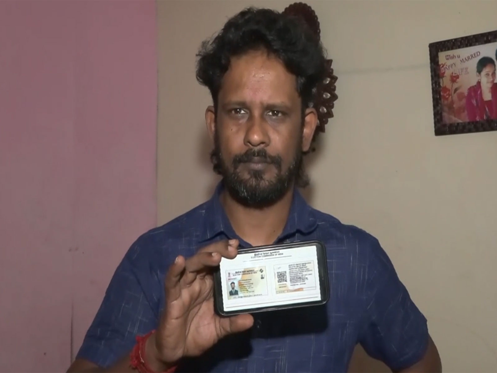 Gokuleswaran, a resident of Sri Lankan Tamils Rehabilitation Camp in Tiruchipalli shows his new voter ID (Photo/ANI)