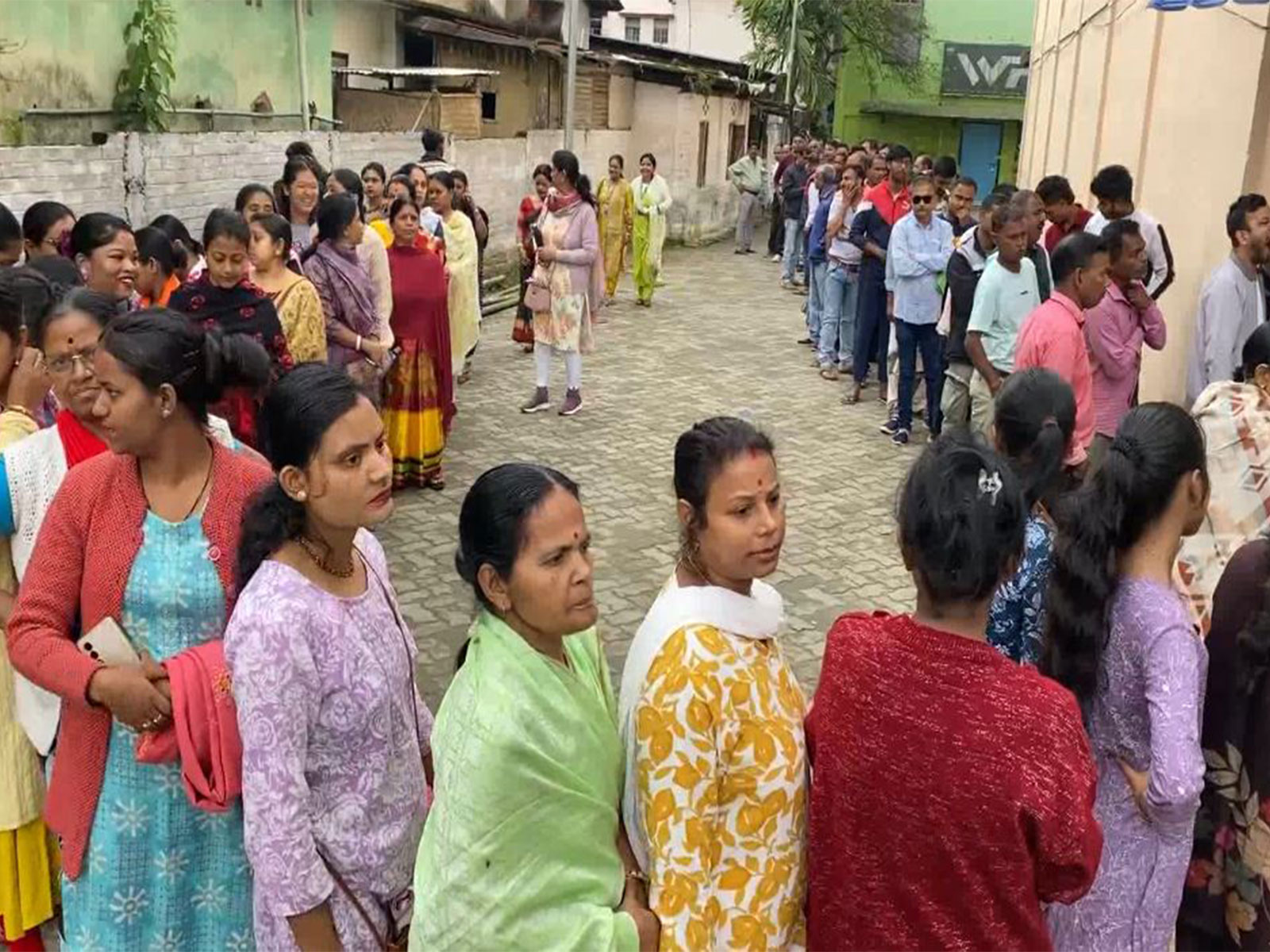 Voters standing in a queue to cast their votes (Photo/ANI)