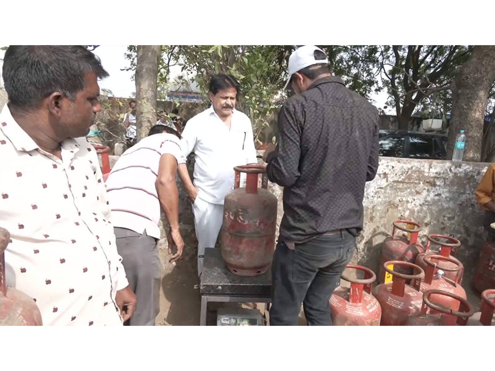Food department officials are measuring the domestic LPG cylinders (Photo/ANI)