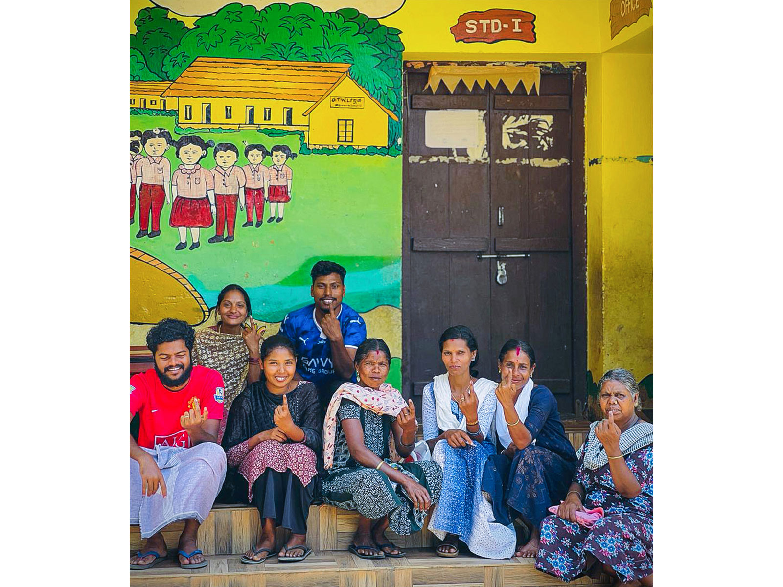 People show their ink-marked fingers after they cast vote for the Kerala assembly election (Photo/ANI)