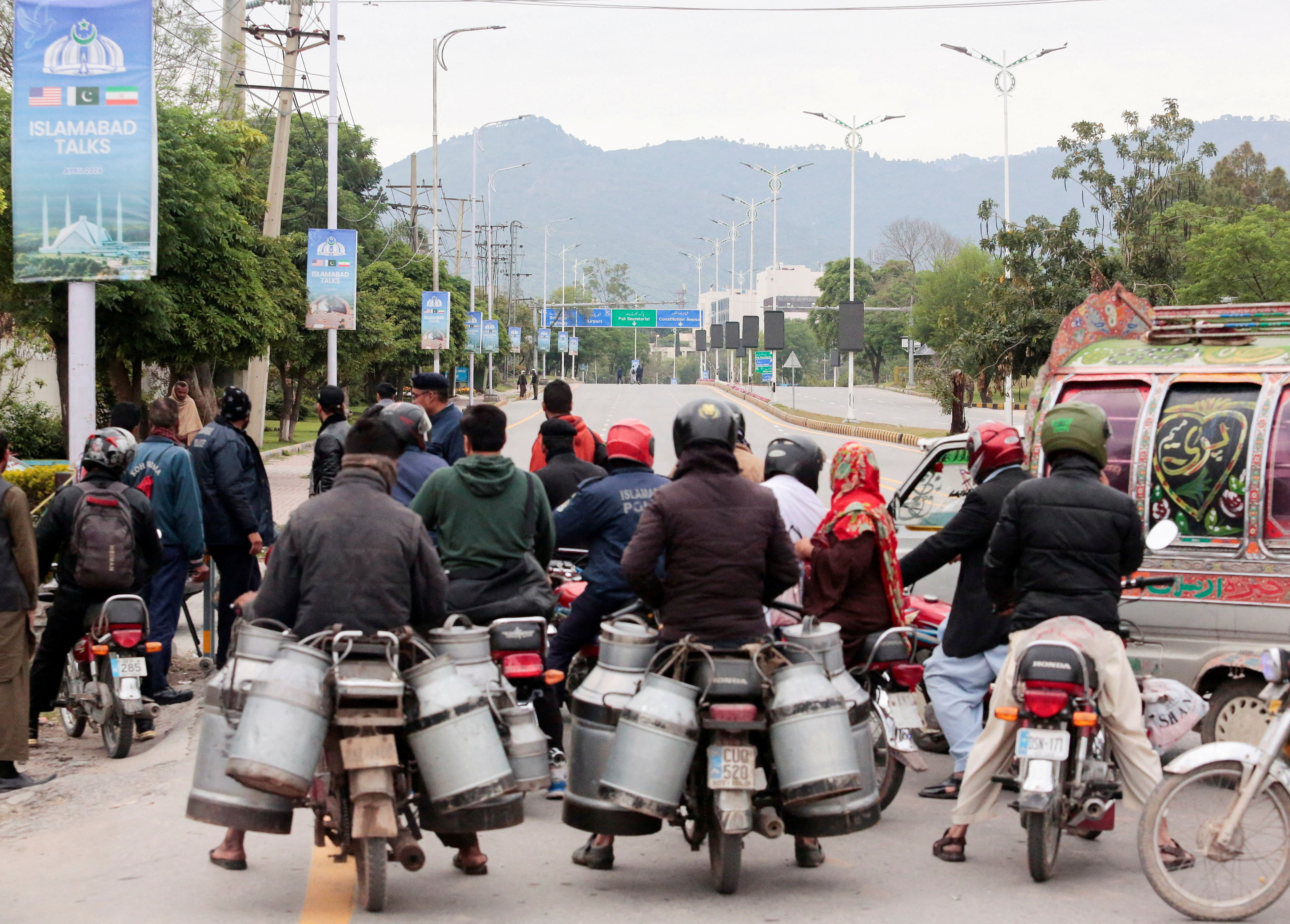 Commuters sit on bikes at a roadblock leading to the Serena Hotel in Pakistan (Photo/Reuters) Commuters sit on bikes at a roadblock leading to the Serena Hotel in Pakistan (Photo/Reuters)