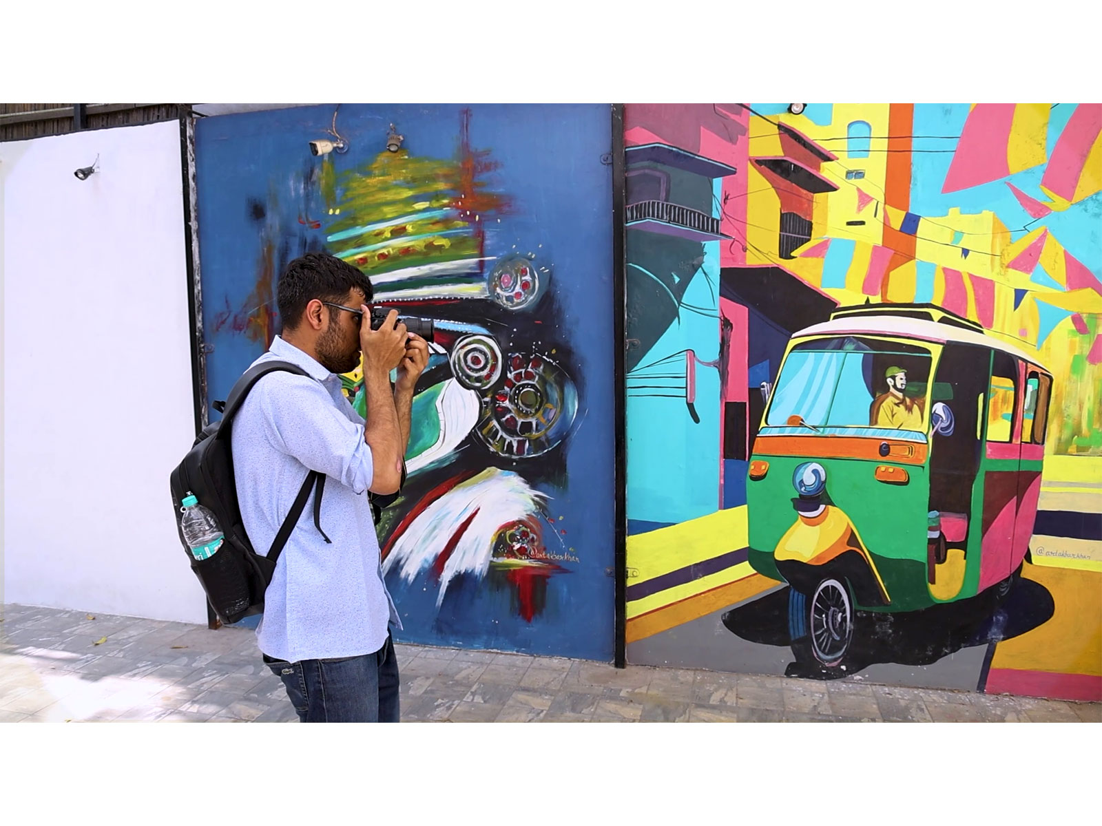 Tourists photographing vibrant artistic graffiti painted on walls. (Photo/ANI)