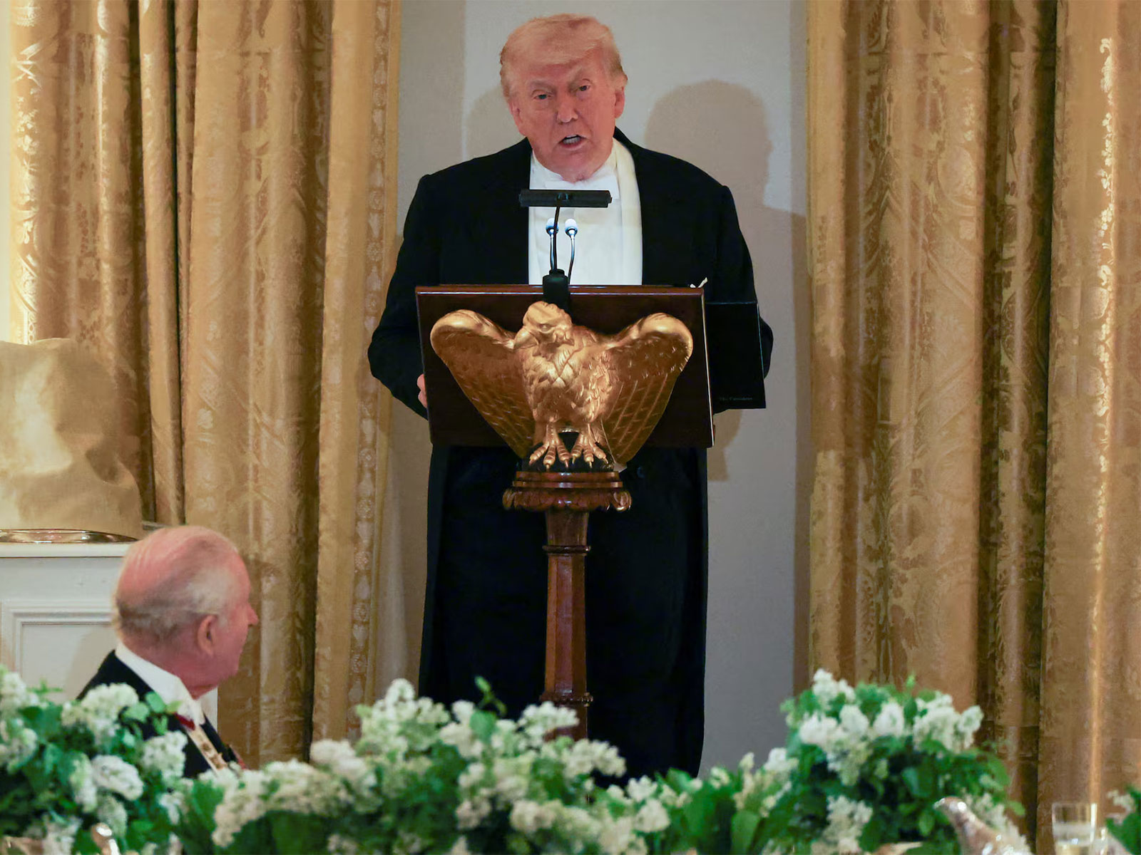 Britain’s King Charles III listens as US President Donald Trump delivers remarks during a state dinner. (Photo/Reuters)