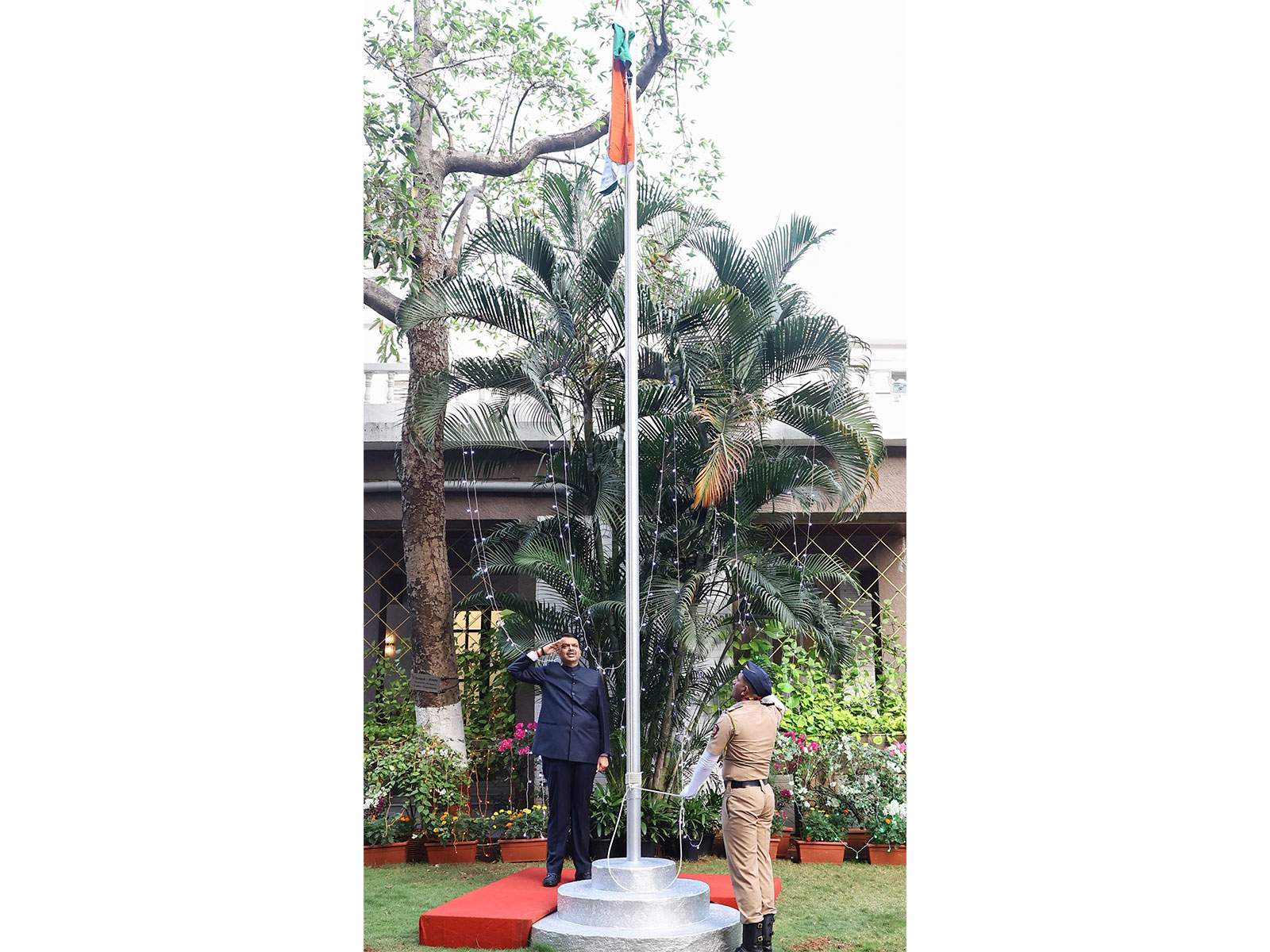 Maharashtra CM Devendra Fadnavis hoists national flag at residence (Photo/@CMOMaharashtra/X)