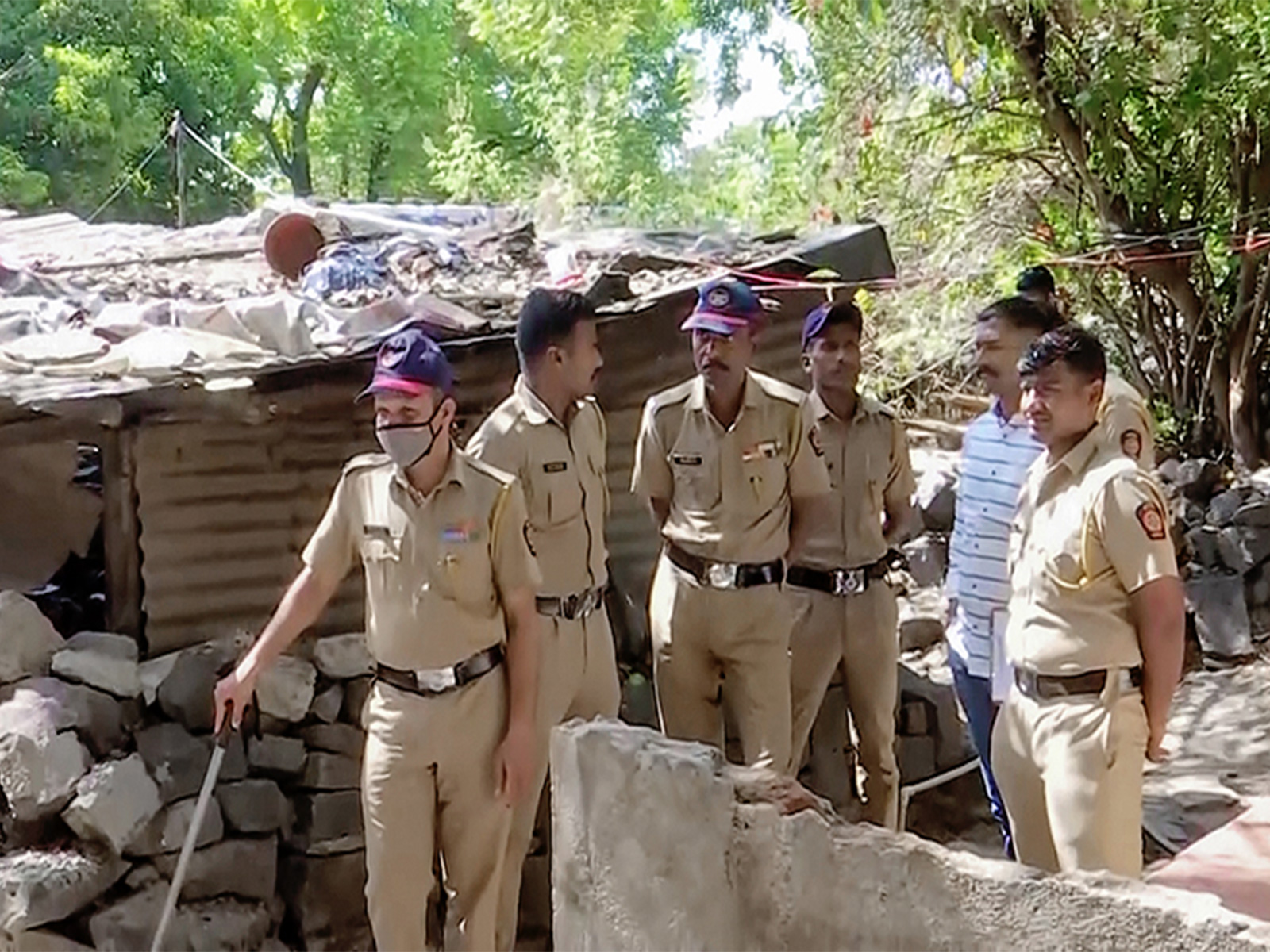 Police at the spot where a 4-year-old girl was allegedly sexually assaulted and murdered by a 65-year-old man in a village in Pune (Photo/ANI)