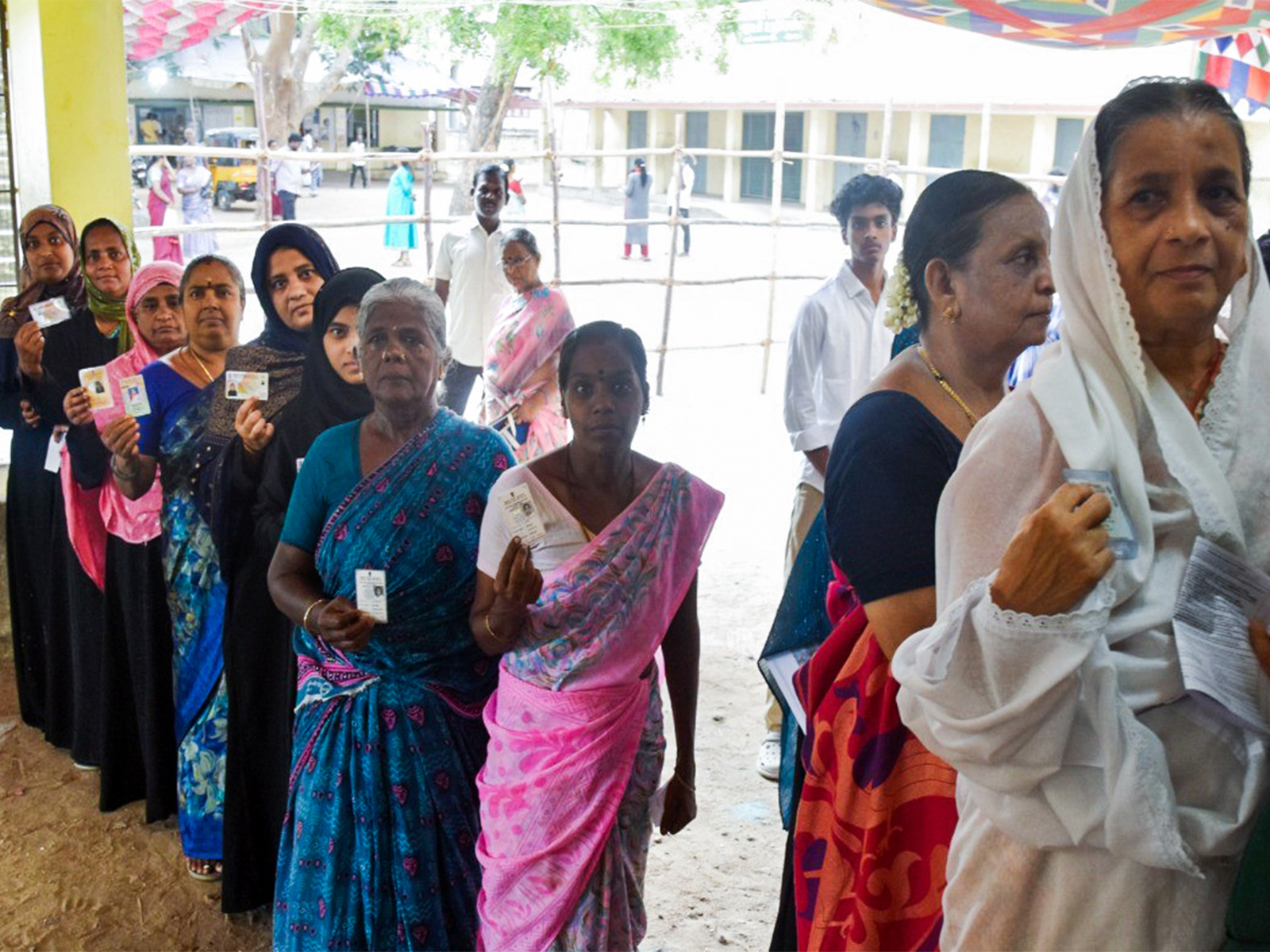 Voters stand in a queue at a polling station to cast their vote in the Tamil Nadu Assembly elections (File Photo/ANI)