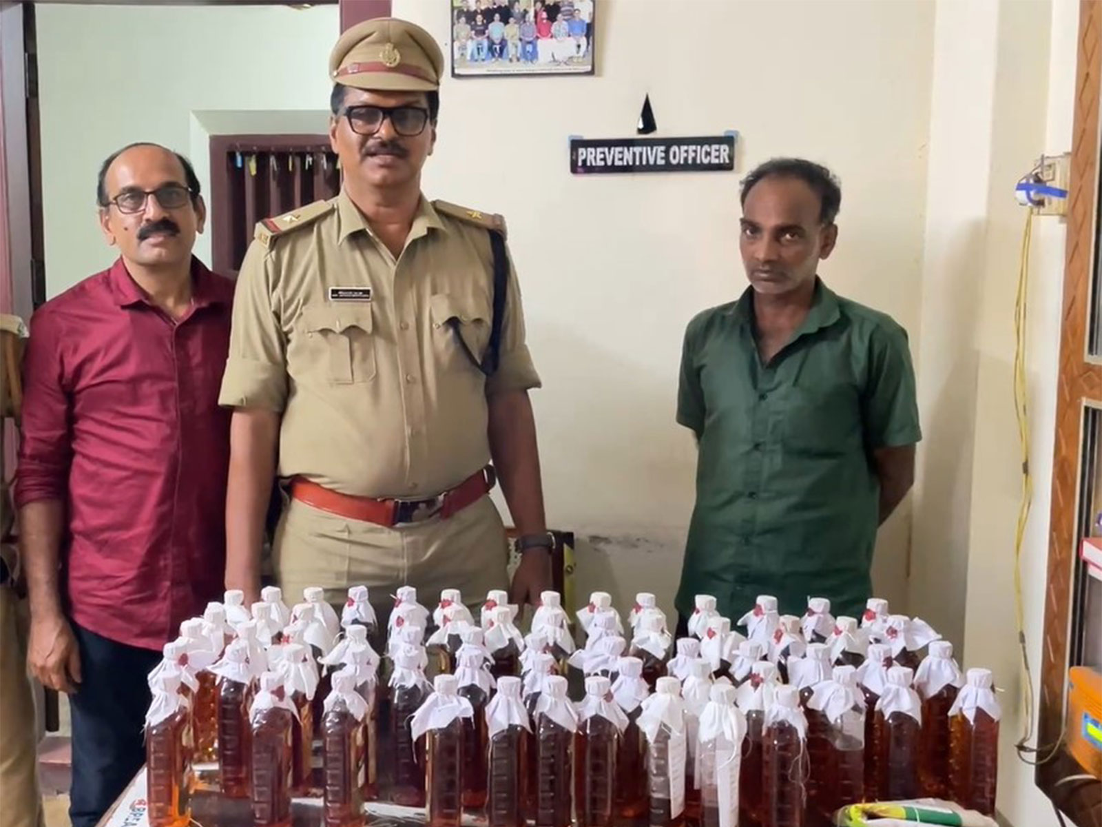 Keralam excise team arrests two with 60 bottles of liquor (Photo/ANI) Keralam excise team arrests two with 60 bottles of liquor (Photo/ANI)