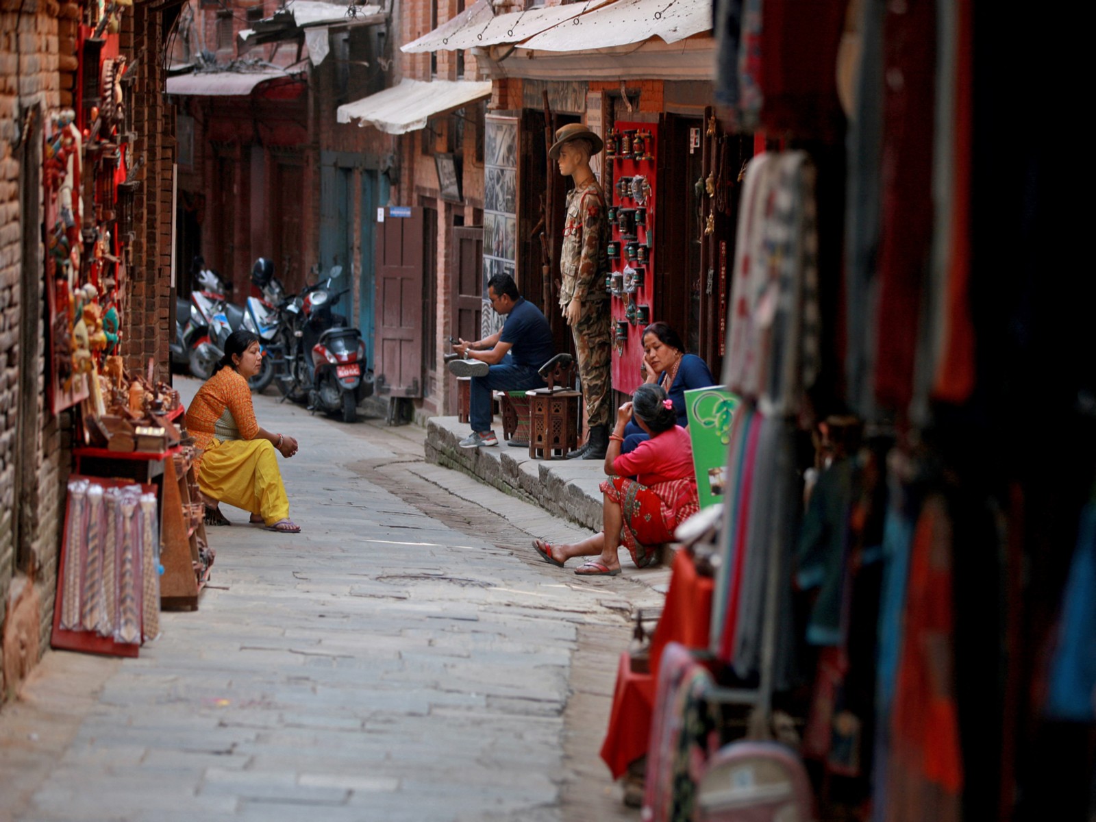 Shopkeepers at a souvenir stall in an alleyway in Bhaktapur, Nepal, keep a watchful eye out for potential buyers. (Photo/Reuters)