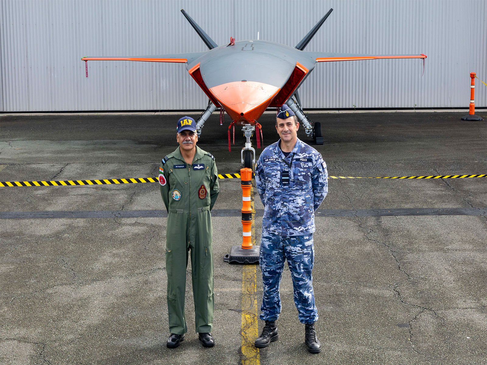 IAF Air Vice-Marshal Sanjeev Taliyan with Australian Deputy Chief of Air Force, Air Vice-Marshal Steven Pesce, with the MQ-28 Ghost Bat in the backdrop. (Photo/Australian Defence Ministry)