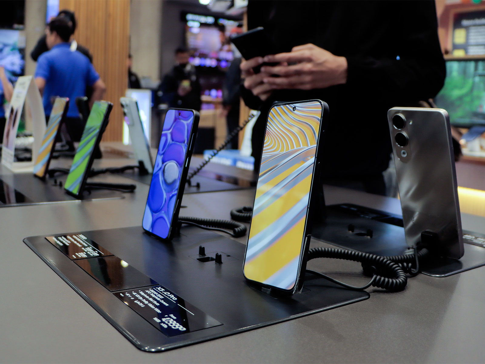 Smartphones are on display at a showroom (Photo/ANI)
