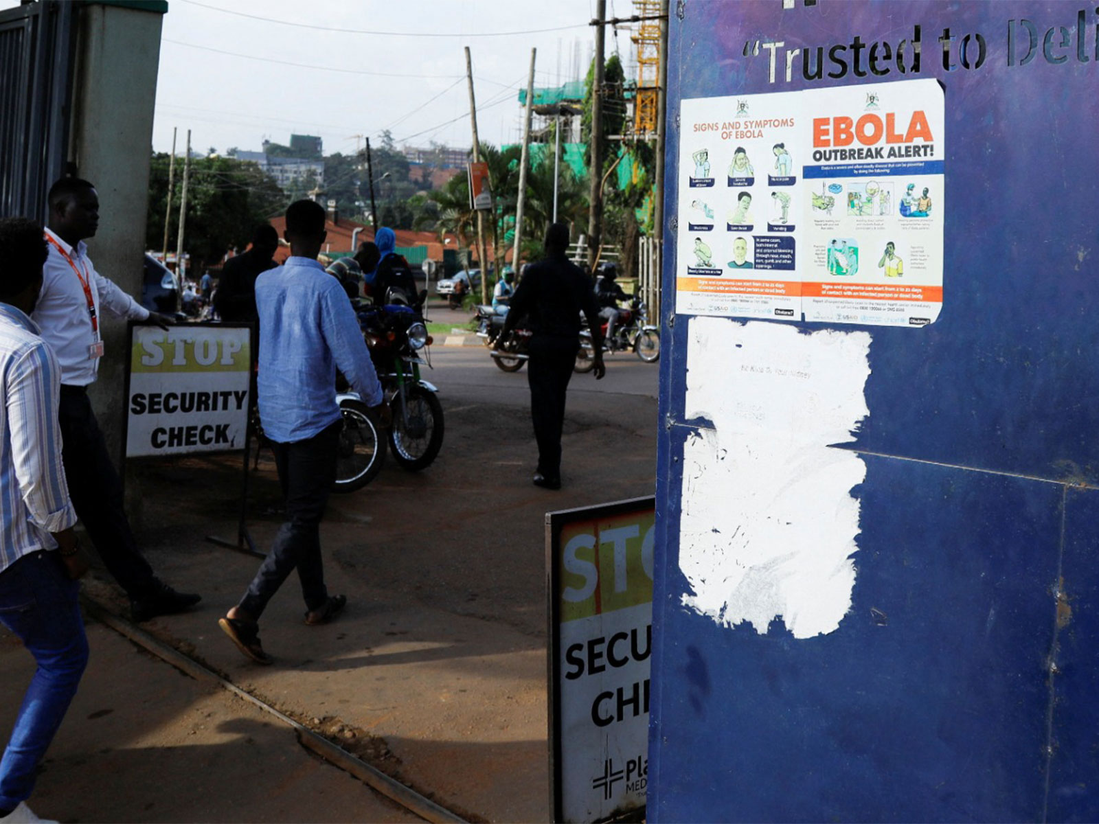 People walk past an advocacy poster against the spread of Ebola virus (Photo/ Reuters)