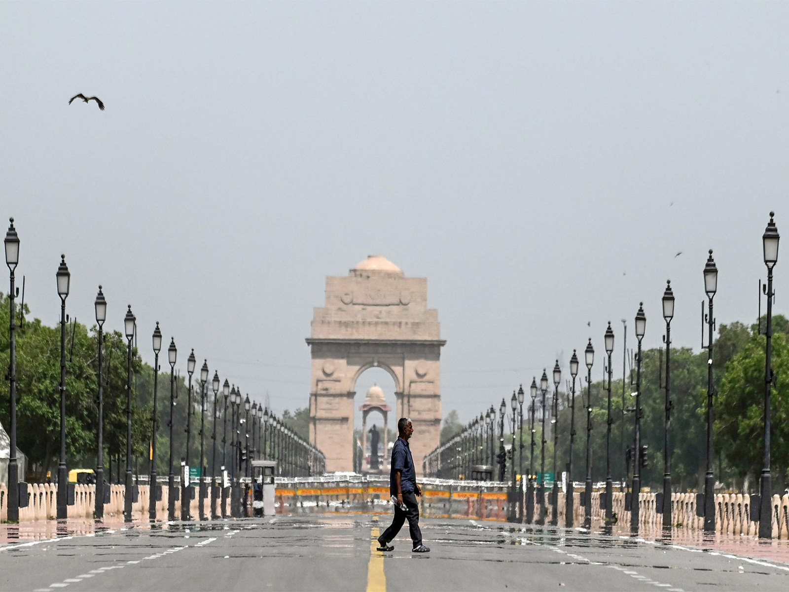 A man walks past the mirages seen at Kartavya Path on a hot summer day, in New Delhi (Photo/ANI) A man walks past the mirages seen at Kartavya Path on a hot summer day, in New Delhi (Photo/ANI)