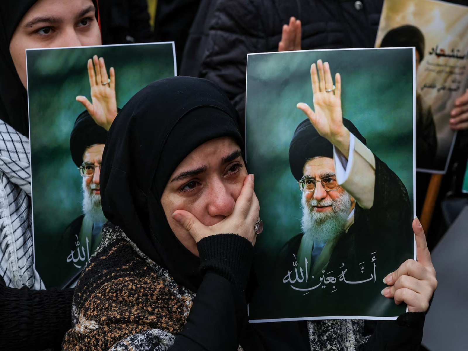 A woman holds a placard bearing an image of the late Iranian Supreme Leader Ayatollah Ali Khamenei. (Photo/Reuters)