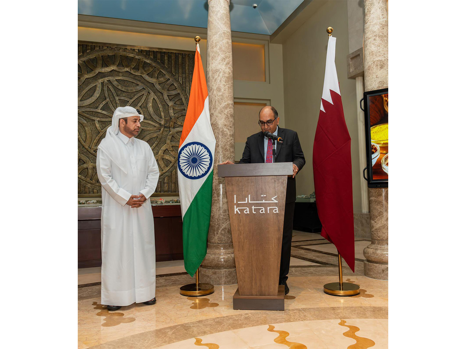 Diplomat Vipul, India’s next envoy to Saudi Arabia, addressing an event from behind a podium emblazoned with 