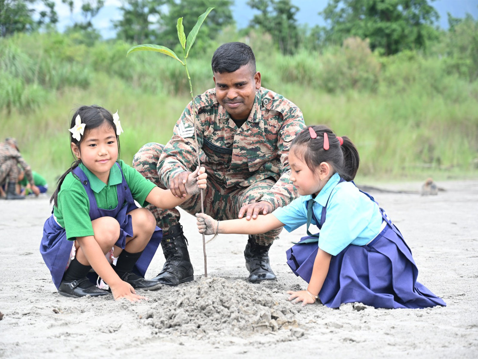 Personnel of the Spear Corps’ Spearhead Division and local children participate in a plantation drive. (Photo/ Spear Corps)