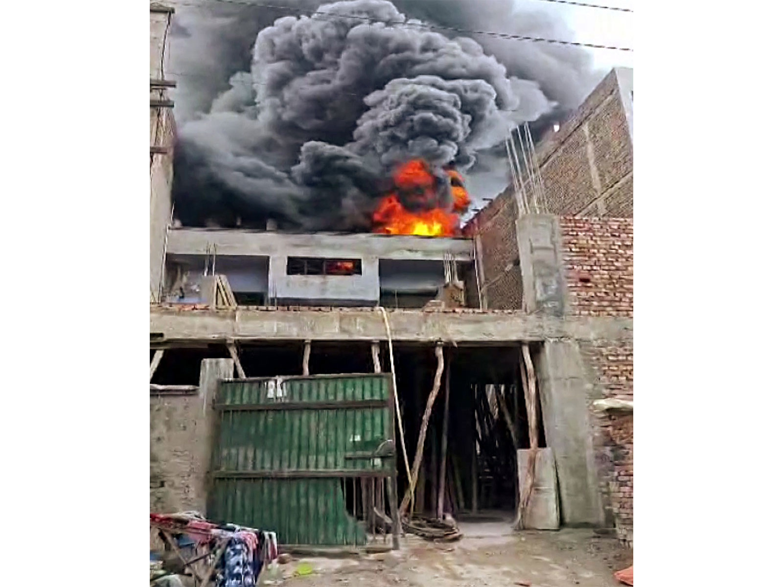 Smoke and flames billow out as fire breaks out in plastic factory in Narela Industrial Area, in Delhi (Photo/ANI) Smoke and flames billow out as fire breaks out in plastic factory in Narela Industrial Area, in Delhi (Photo/ANI)