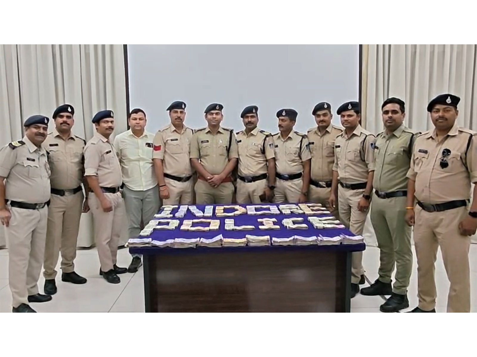 Police team with money recovered from the accused (Photo/ANI)