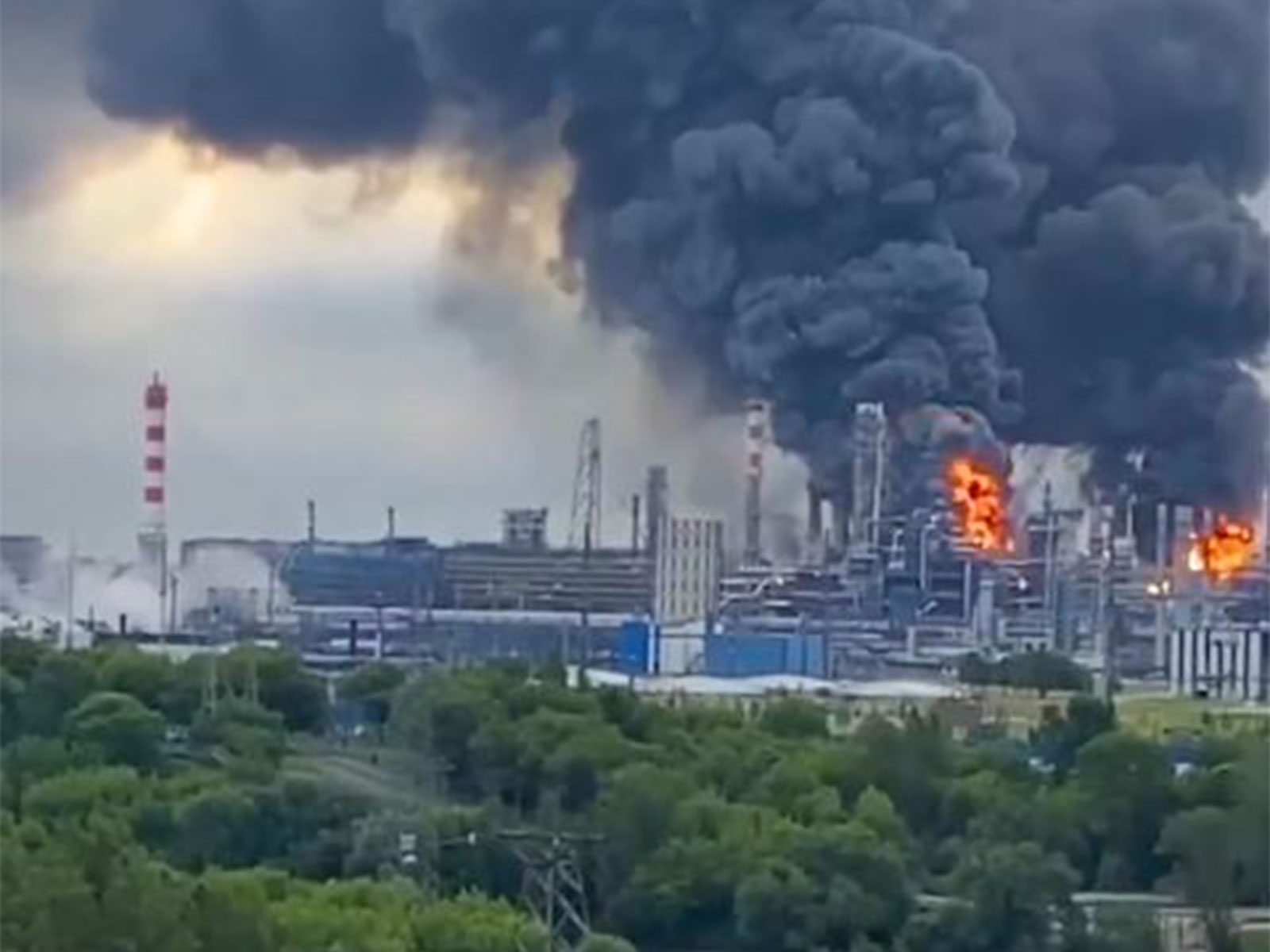 Thick plumes of smoke with flames rise from an oil refinery (Photo/X@ZelenskyyUa)