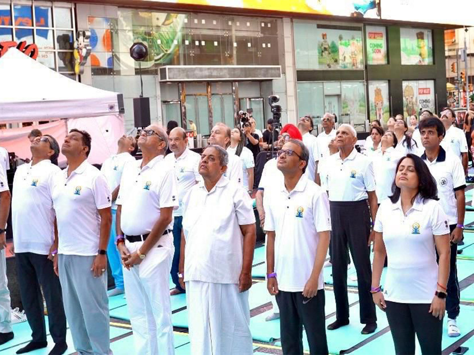 Om’ resonates at Times Square as yogis celebrate International Day of Yoga (Photo/ANI) Om’ resonates at Times Square as yogis celebrate International Day of Yoga (Photo/ANI)