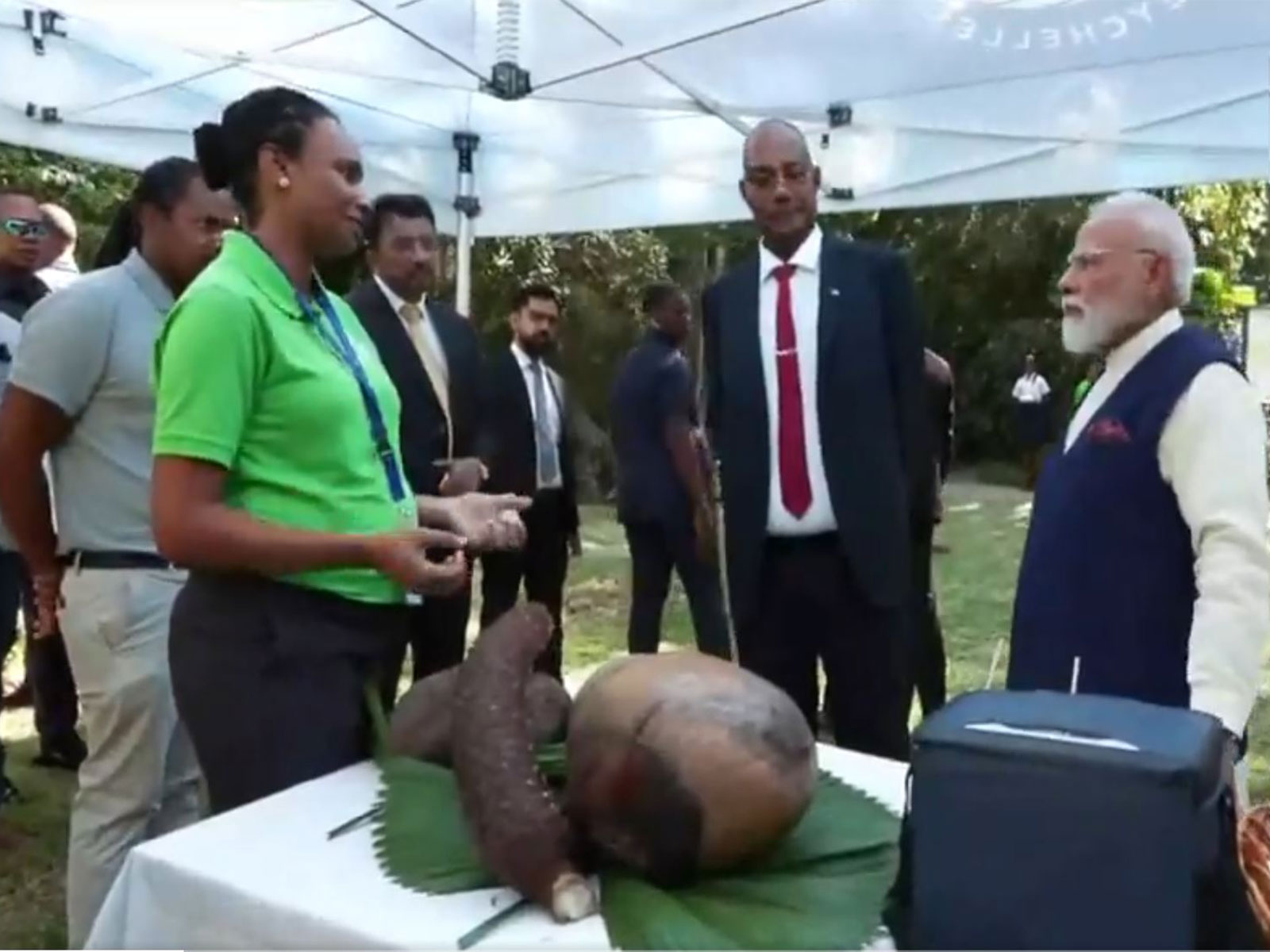Prime Minister Narendra Modi interacts with officials during his visit to the Seychelles National Botanical Garden, accompanied by Seychelles President Patrick Herminie, as part of his State Visit to the island nation. (Image Source: ANI/DD)