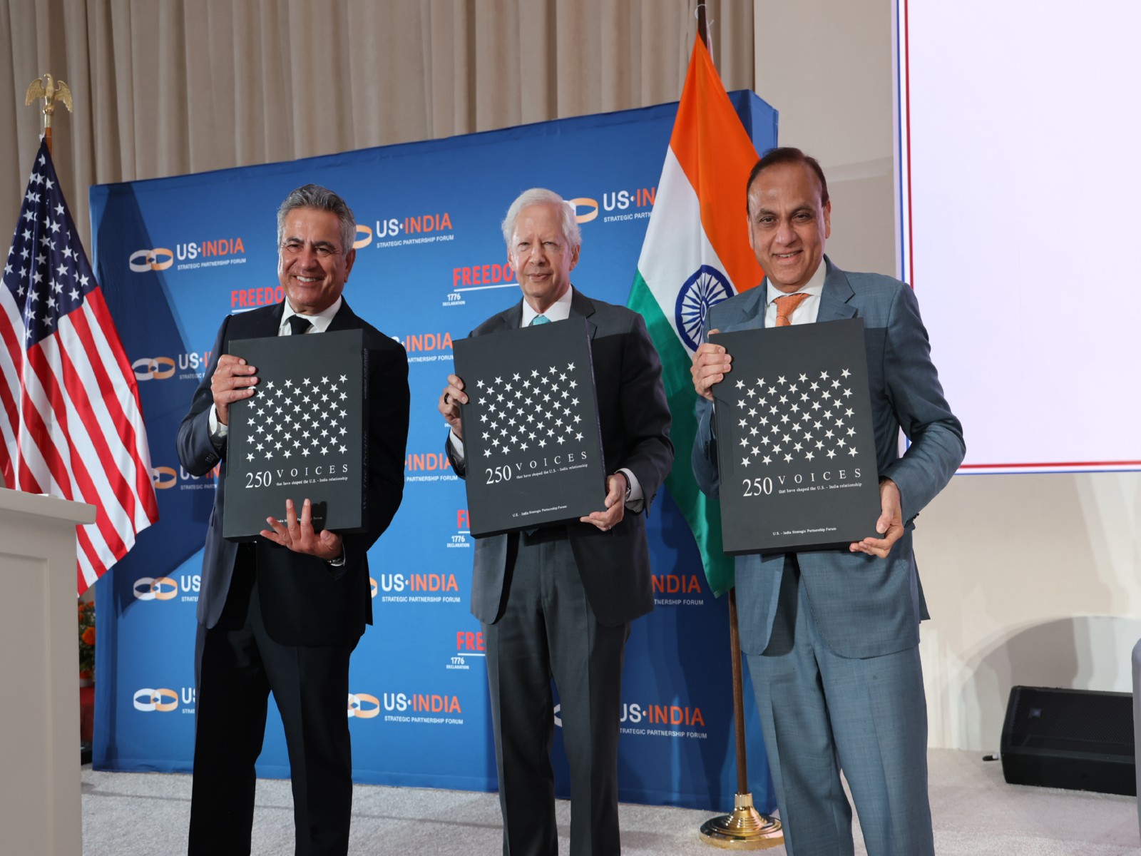 Mukesh Aghi, President and CEO of USISPF (L) and Former United States Ambassador to India Kenneth Juster (Center) with second edition of its coffee table book titled 'We The People' (Photo/X@USISPForum) Mukesh Aghi, President and CEO of USISPF (L) and Former United States Ambassador to India Kenneth Juster (Center) with second edition of its coffee table book titled 'We The People' (Photo/X@USISPForum)