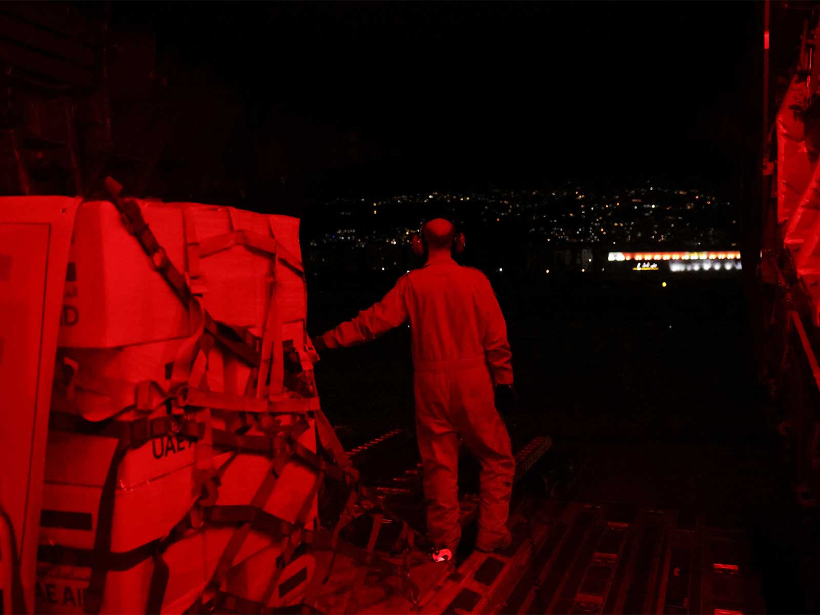 A United Arab Emirates military member stands next to palettes of aid for Lebanon after a UAE cargo aircraft landed (Photo/Reuters)