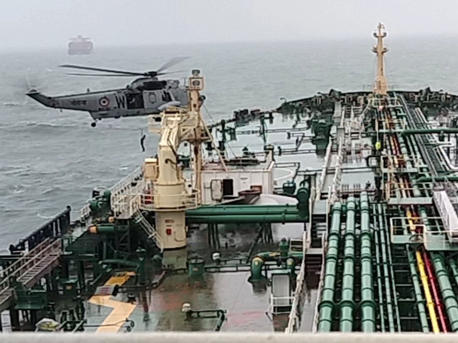 Indian Navy helicopter airlifts injured sailor (Photo/@IndiaCoastGuard)