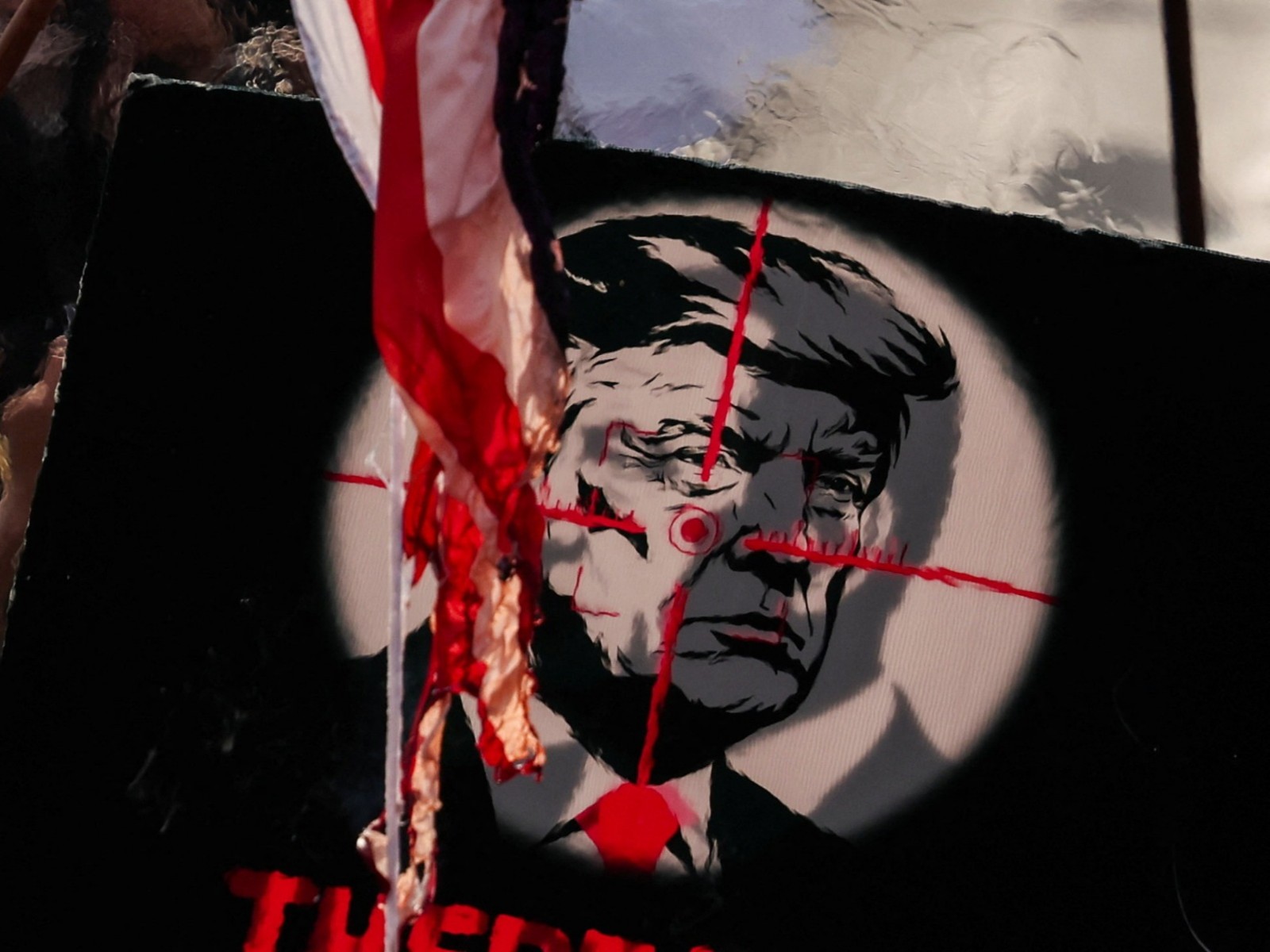 Mourners carry protest banners seeking death of US President Donald Trump (Photo/Reuters)