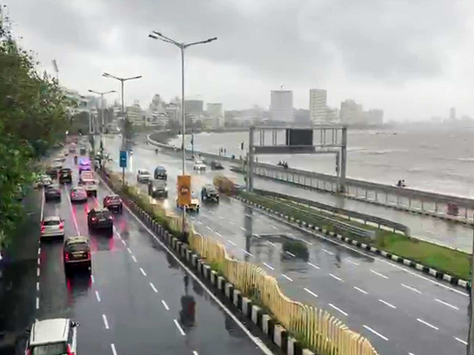 Vehicles ply along rain-lashed Marine Drive amid rough sea conditions in Mumbai (Photo/ANI) Vehicles ply along rain-lashed Marine Drive amid rough sea conditions in Mumbai (Photo/ANI)