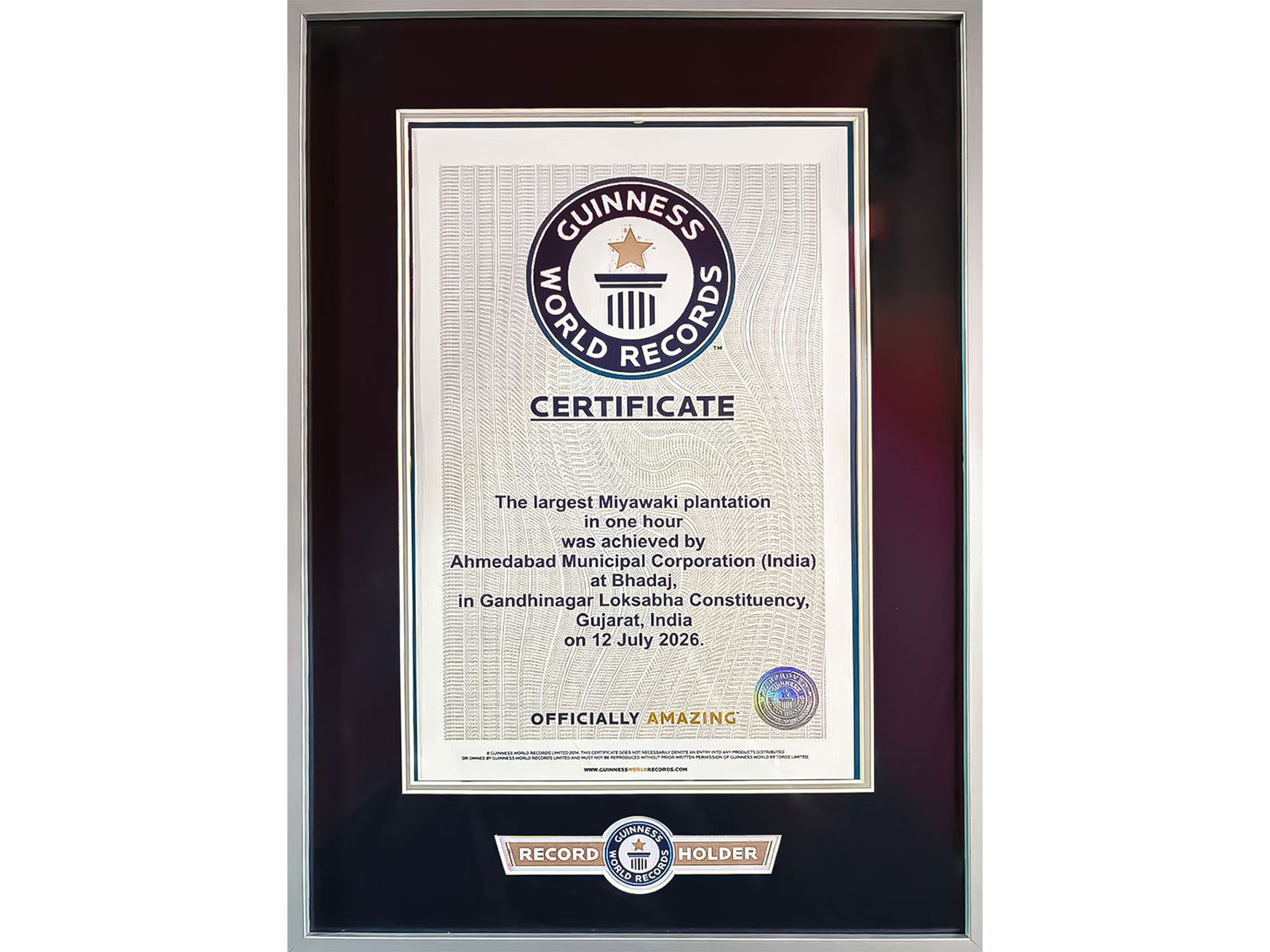 Officials of the Ahmedabad Municipal Corporation (AMC) receive the Guinness World Record certificate after successfully planting 3.61 lakh trees in one hour (Photo/@AmitShah)