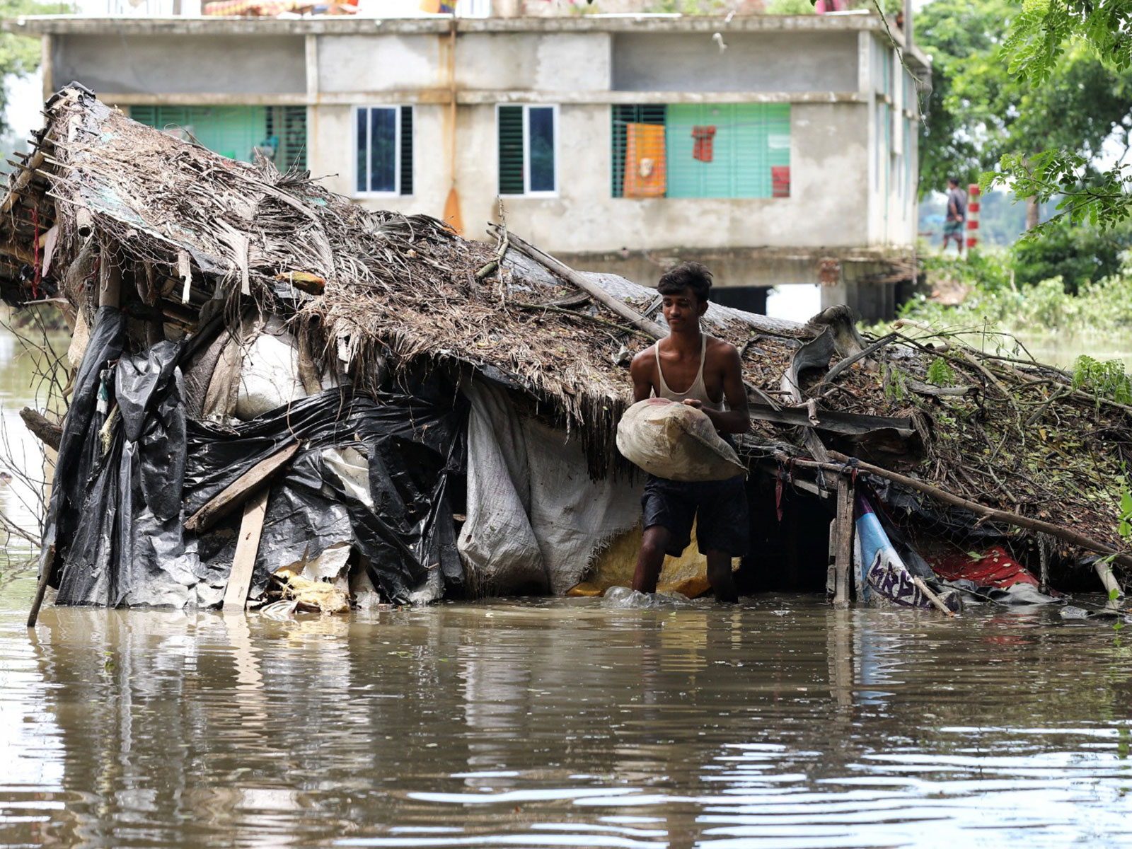 A man removes his belongings from the flooded house, as severe flood hits following torrential rain in Chattogram, Bangladesh (Photo/Reuters)