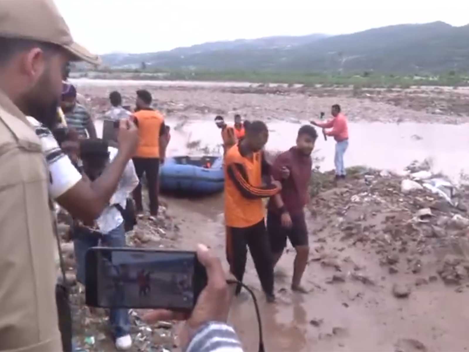 Jammu Police and NDRF personnel rescue one of the youths stranded in Tawi River (Photo/ANI)