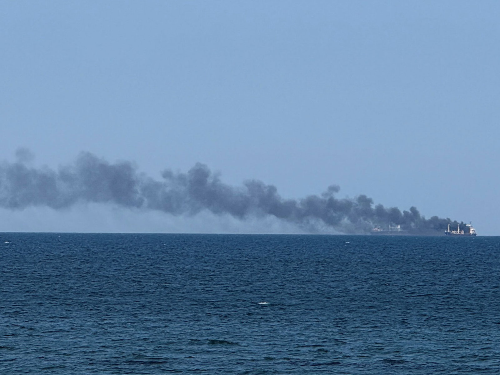 Smoke rises from a civilian vessel on fire in Odesa (Photo/Reuters)
