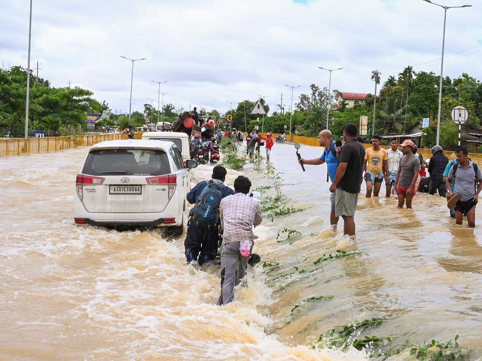 Floodwaters submerge Jorhat-Sivasagar highway in Assam, commuters struggle through waterlogged roads (Photo/ANI) Floodwaters submerge Jorhat-Sivasagar highway in Assam, commuters struggle through waterlogged roads (Photo/ANI)