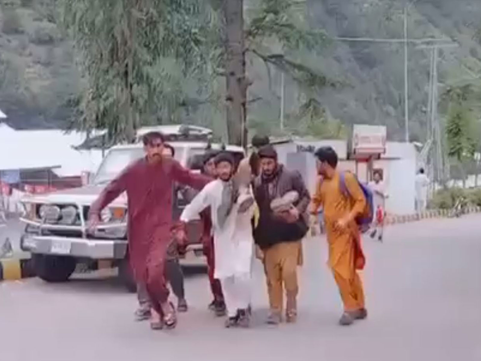 Residents carry an injured protester after security forces reportedly opened fire during demonstrations in Athmuqam Tehsil, Neelum Valley, amid the second phase of the so-called legislative elections in Pakistan-occupied Jammu and Kashmir (PoJK) on Sunday. (Image Source: Jammu Kashmir Joint Awami Action Committee)