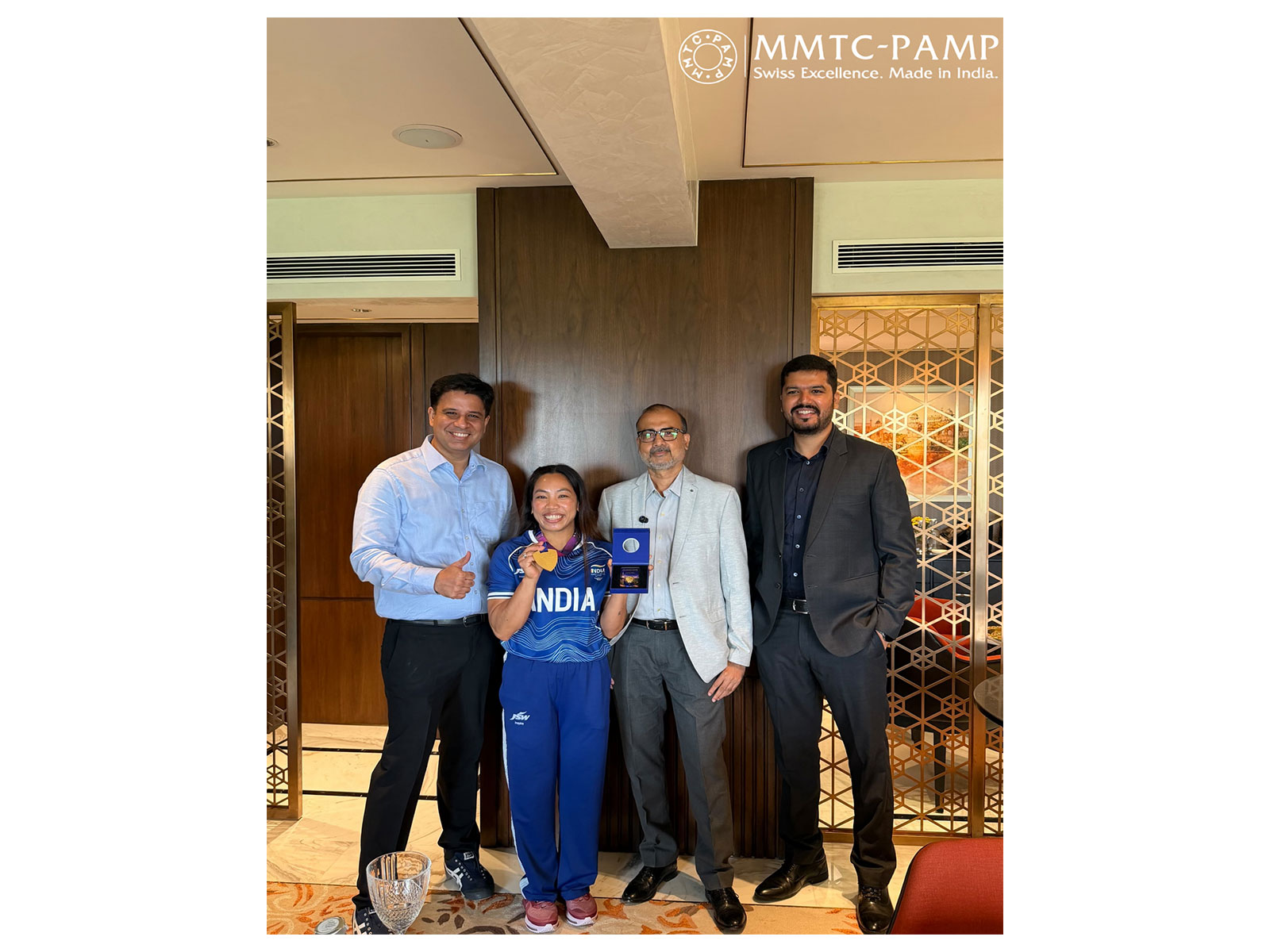 Mr. Samit Guha, MD and CEO, MMTC-PAMP, unveils the Limited Edition 10gm Virasat Recycled Gold Coin and presents the first coin to CWG 2026 Gold Medalist Mirabai Chanu