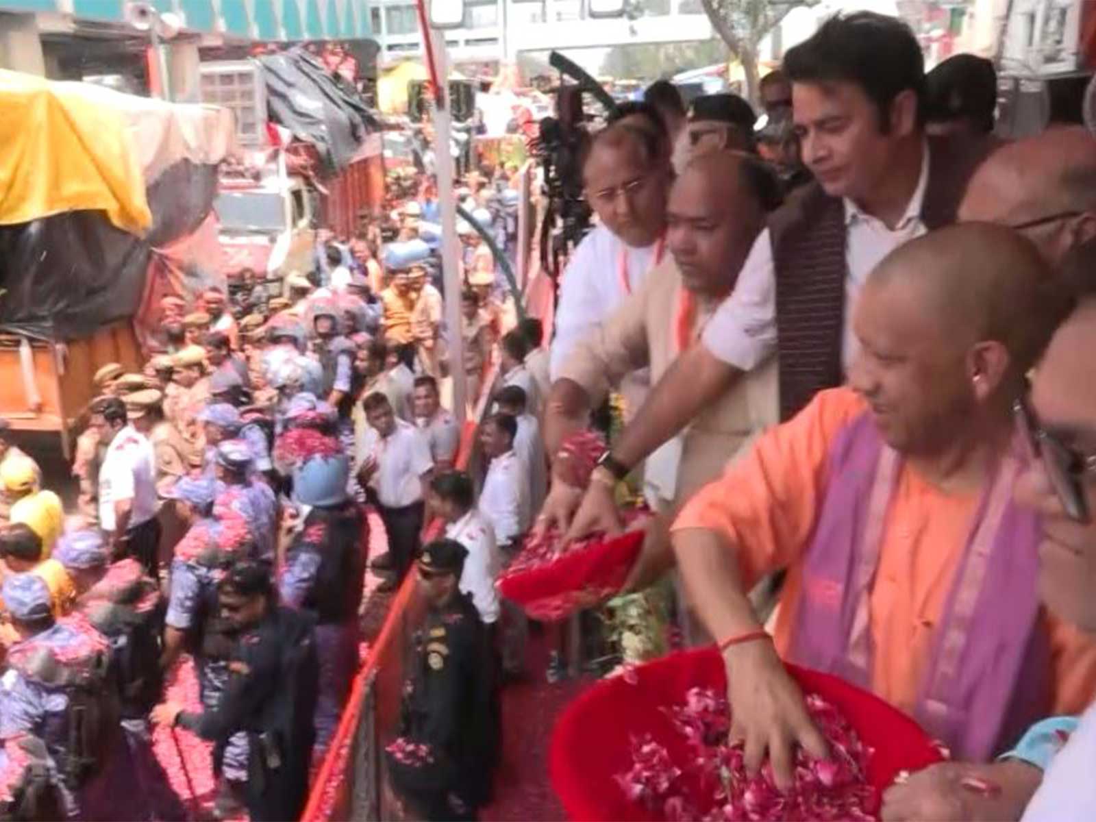 Uttar Pradesh Chief Minister Yogi Adityanath showers flower petals on Kanwariyas in Meerut (Photo/ANI)