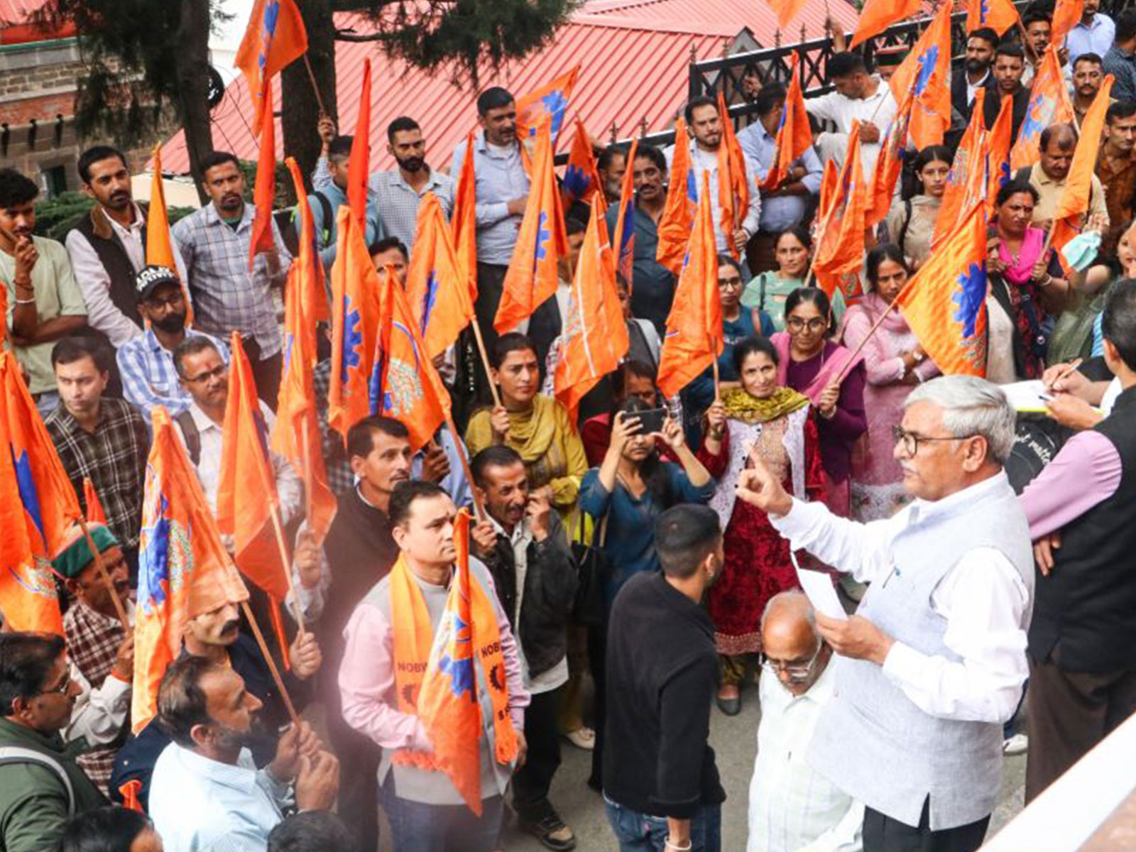 Members of Bharatiya Mazdoor Sangh stage a protest outside the DC office in Shimla (Photo/ANI) Members of Bharatiya Mazdoor Sangh stage a protest outside the DC office in Shimla (Photo/ANI)