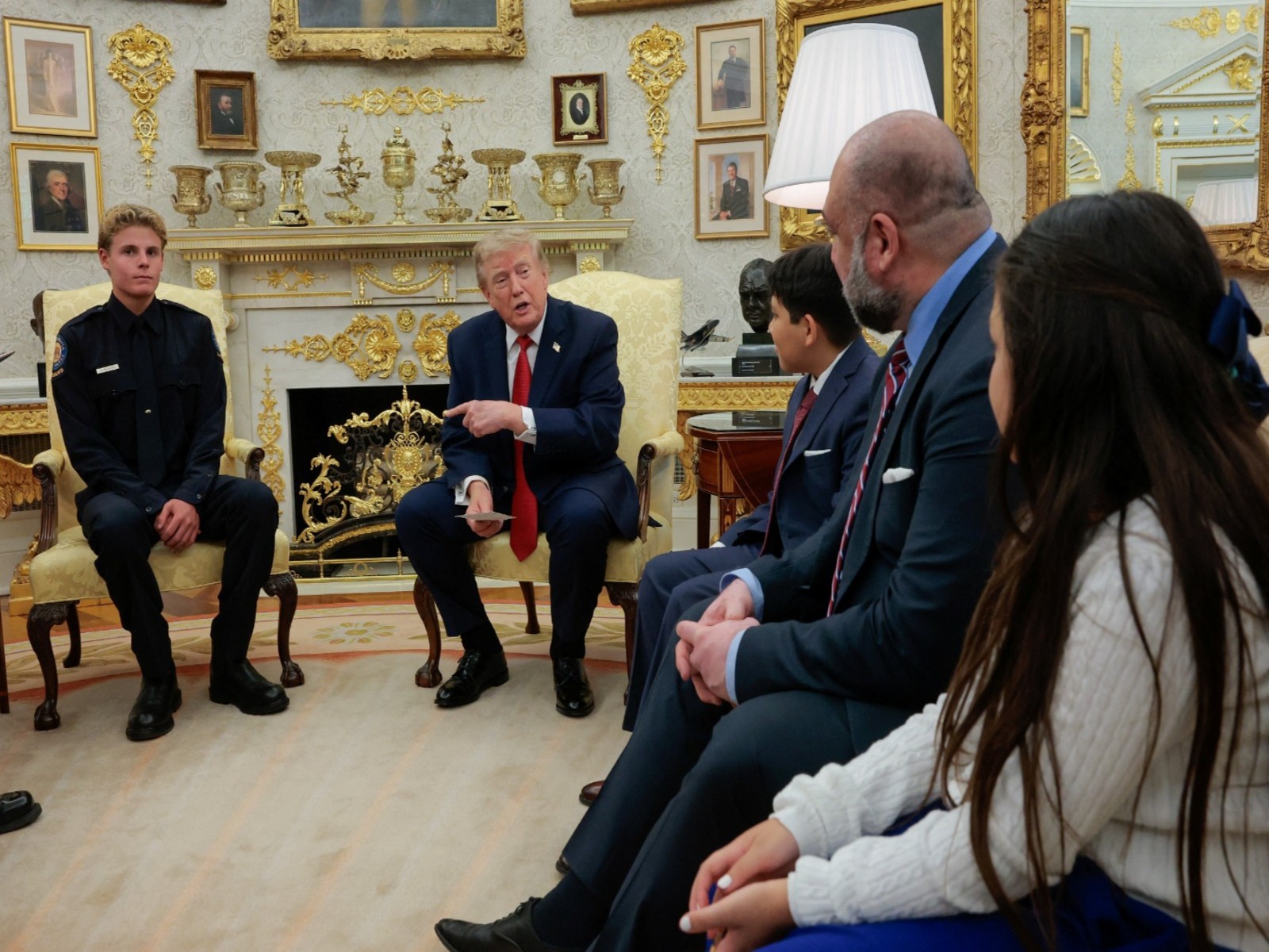 U.S. President Donald Trump hosts 16-year-old lifeguard Ryder Williams, who saved a child off the coast of Santa Cruz, California, last month, and Nathaniel Rai, the child saved by Williams, in the Oval Office at the White House in Washington (Photo/Reuters) U.S. President Donald Trump hosts 16-year-old lifeguard Ryder Williams, who saved a child off the coast of Santa Cruz, California, last month, and Nathaniel Rai, the child saved by Williams, in the Oval Office at the White House in Washington (Photo/Reuters)