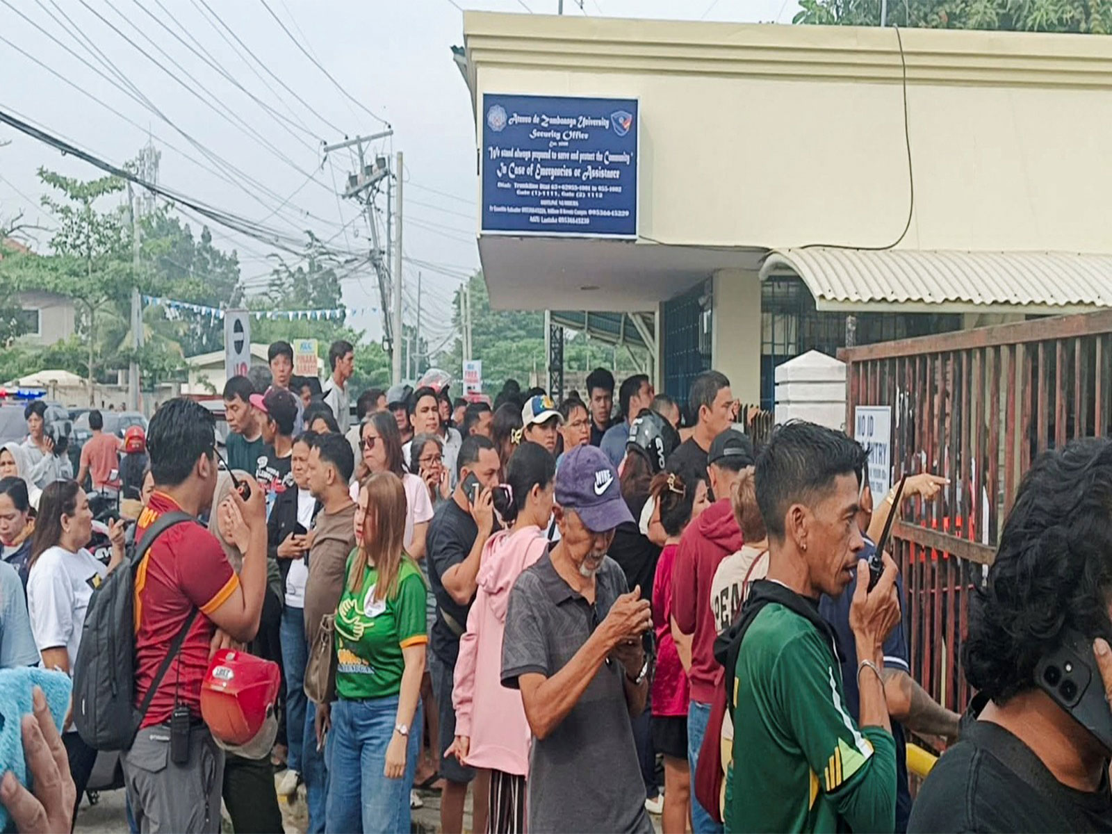 People stand outside Ateneo de Zamboanga University after a shooting that killed two people, in Zamboanga, southern Philippines (Photo/Reuters) People stand outside Ateneo de Zamboanga University after a shooting that killed two people, in Zamboanga, southern Philippines (Photo/Reuters)