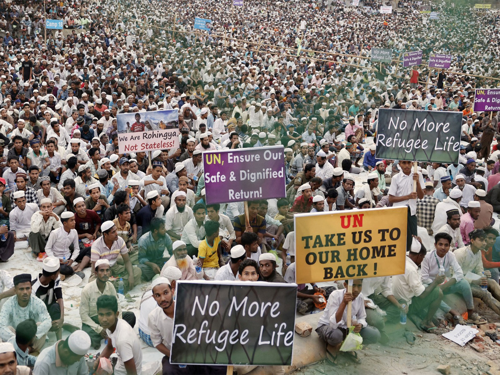 Rohingya refugees hold placards while attending a Ramadan Solidarity Iftar in Cox's Bazar, Bangladesh (File Photo/Reuters)
