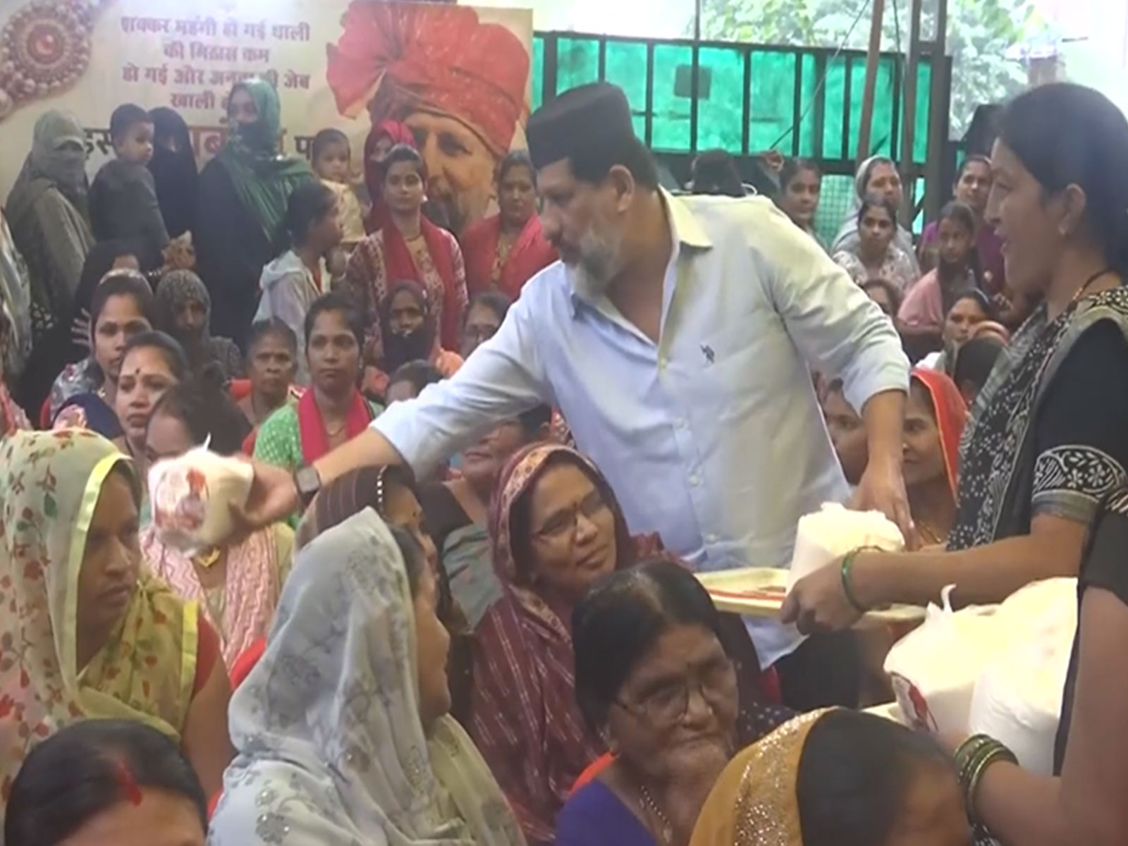 Congress MLA Arif Masood is distributing sugar packets to women at his residence (Photo/ANI)