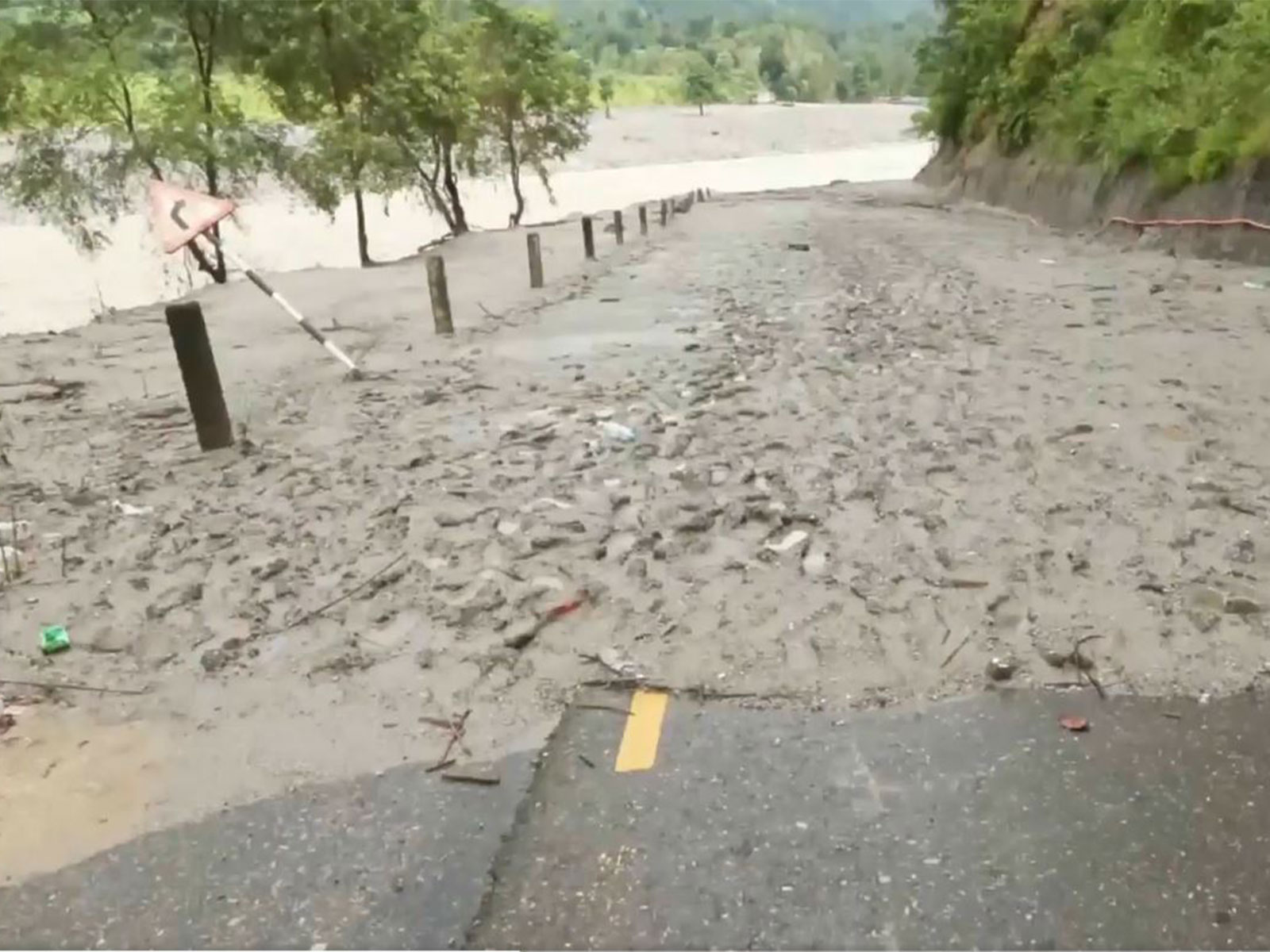 Road completely washed away and merged into the river in Betrawati region (Photo/ANI)