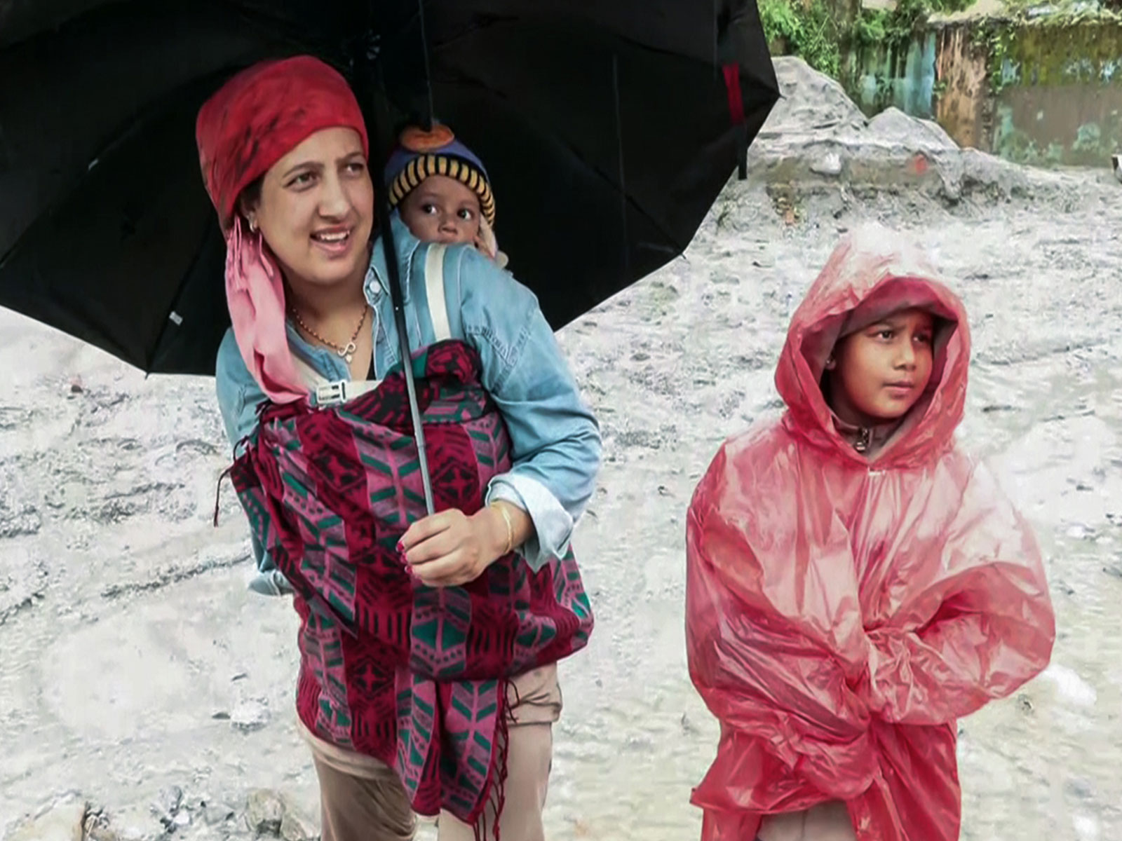 A mother carries one child on her back and another with her after flash-floods devastating Trishuli area (Photo/ANI) A mother carries one child on her back and another with her after flash-floods devastating Trishuli area (Photo/ANI)