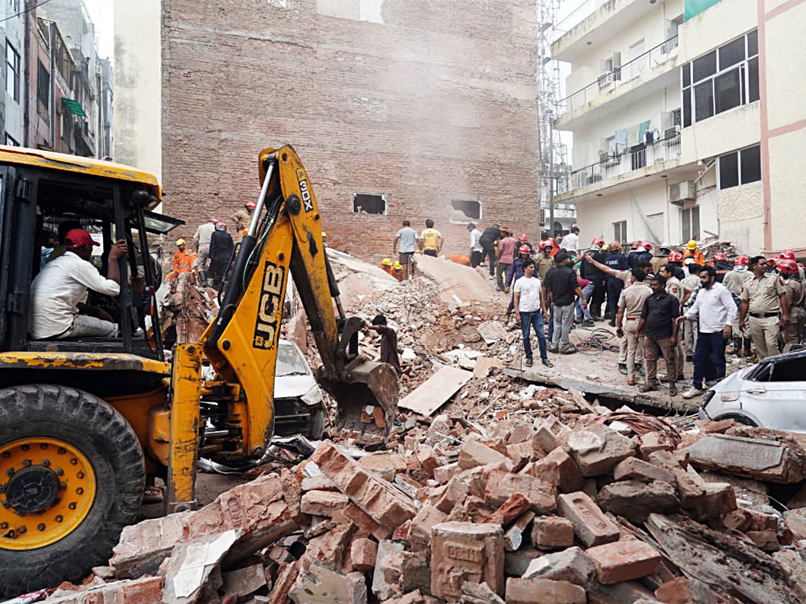 JCB machines carry out rescue operations at the site of a building collapse at Satya Niketan (Photo/ANI) JCB machines carry out rescue operations at the site of a building collapse at Satya Niketan (Photo/ANI)