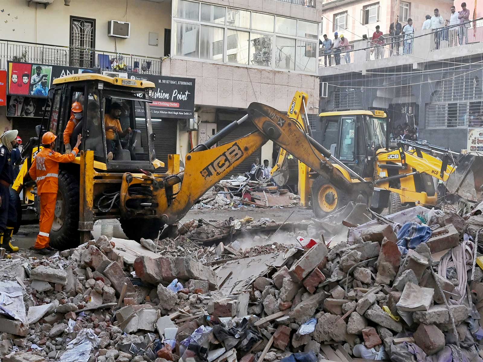 Rescue operations underway at the site of a building collapse near Satya Niketan (Photo/ANI)