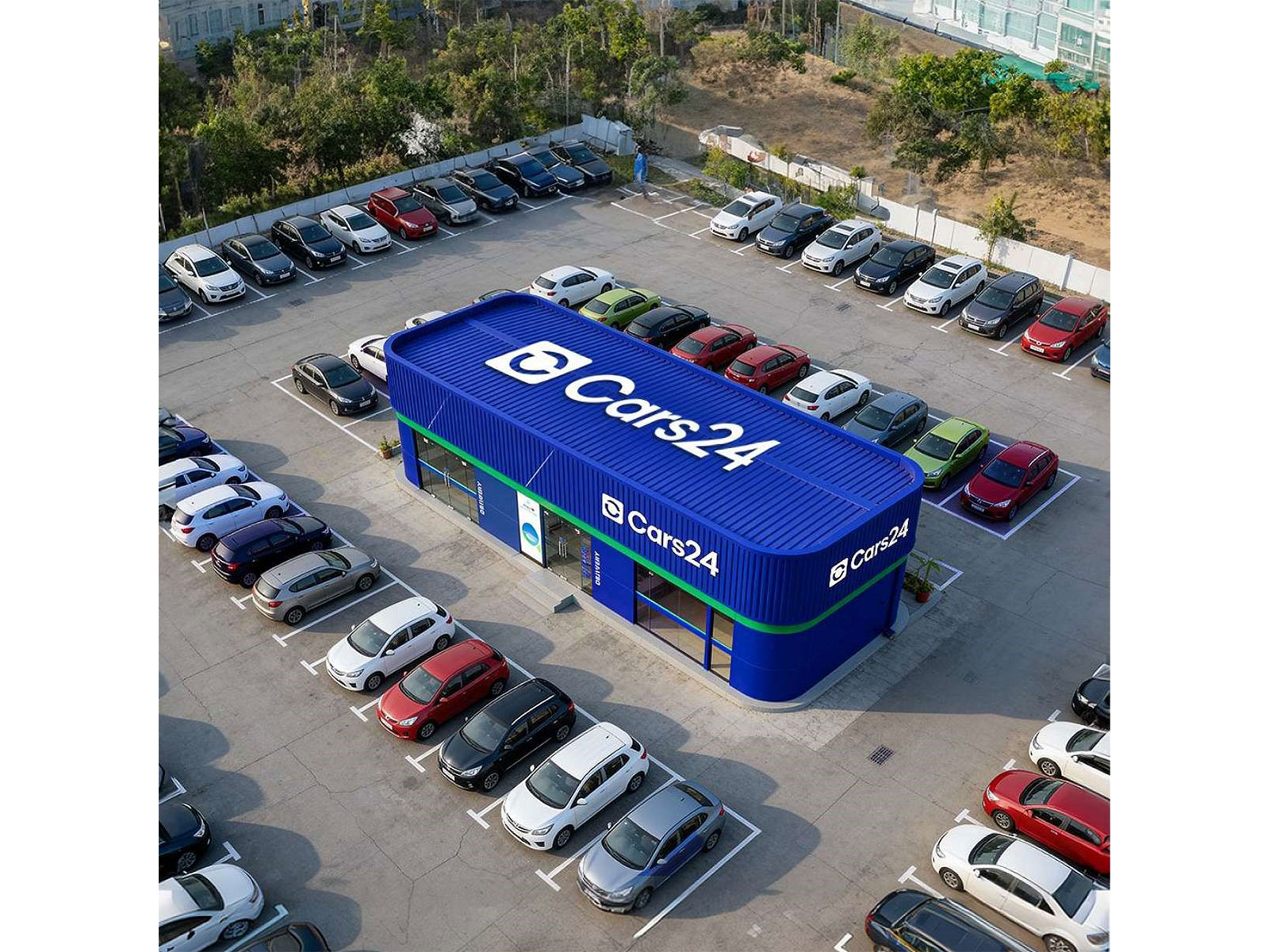 An aerial view of a Cars24 facility showcasing its modern infrastructure and extensive vehicle inventory