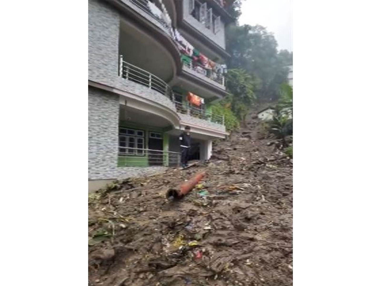 Landslide in Sikkim's Gangtok partially damages house (Photo/ANI) Landslide in Sikkim's Gangtok partially damages house (Photo/ANI)