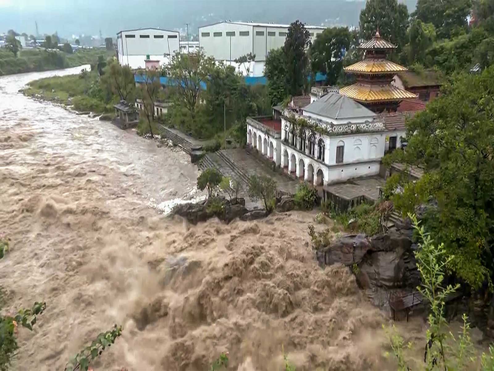 Swollen Bagmati River overflows banks in Kathmandu after heavy rain (Photo/ANI) Swollen Bagmati River overflows banks in Kathmandu after heavy rain (Photo/ANI)