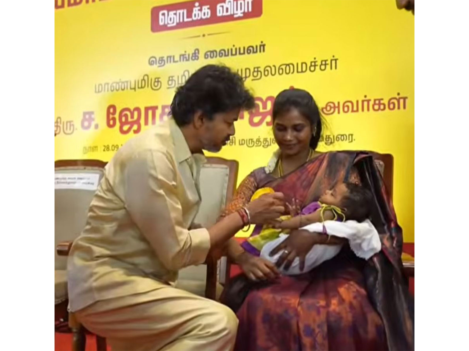Tamil Nadu Chief Minister C. Joseph Vijay presents a Gold ring to a newborn child (Photo/TNDIPR) Tamil Nadu Chief Minister C. Joseph Vijay presents a Gold ring to a newborn child (Photo/TNDIPR)